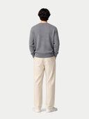 back view of a person wearing a gray sweater and beige pants on a white background #color_dim-gray
