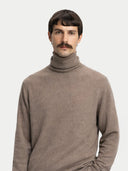 Man wearing a brown turtleneck sweater against a white background #color_taupe