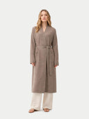 Woman wearing a long brown robe on a white background #color_taupe