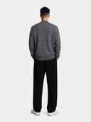 back view of a person wearing a gray sweater and black pants on a white background #color_plum-kitten