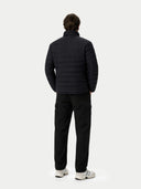 back view of a person wearing a black puffer jacket and pants on a white background  #color_black