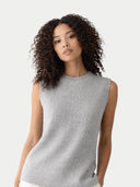 Close up of woman wearing a gray sleeveless knitted top against a plain background #color_high-rise