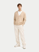 front view of a man wearing a beige v-neck cardigan over a white t-shirt and pants on a white background #color_beige