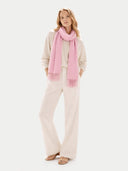 Woman wearing a pink scarf and beige outfit on a white background #color_sweet-lilac