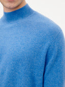 close up of a blue mock neck sweater on a white background #color_blue