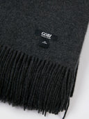 close up of a dark gray blanket with fringes #color_charcoal