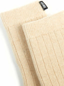 close up of beige socks with patterns and a small dark label "GOBI" #color_beige