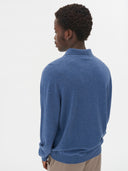 close up back view of a blue polo sweater and beige pants on a light gray background #color_bijou-blue