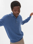 front view of a blue polo sweater, long sleeve and beige pants on a light gray background #color_bijou-blue