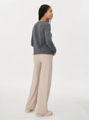 back view of a gray sweater and white pants on a white background  #color_stone-gray
