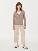 front view of a woman wearing a beige v-neck cardigan and pants  #color_taupe