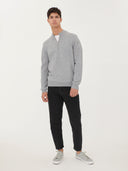 front view of a man standing, a gray quarter zip cardigan and black jeans on a light gray background.  #color_vapor-blue