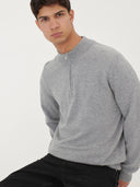 front view of a man sitting, wearing a gray half-zip cardigan and black jeans on a light gray background  #color_vapor-blue