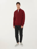 front view of a man wearing a red quarter cardigan and black jeans #color_bordeaux