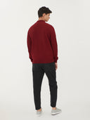 back view of a man wearing a red quarter cardigan and black jeans #color_bordeaux