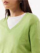 close up of a green v-neck long sleeve sweater #color_jade-lime