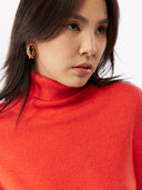 close up front view of woman wearing a red turtle neck sweater #color_fiesta