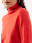 close up front view of woman wearing a red turtle neck sweater #color_fiesta