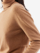close up of an almond color sweater with long sleeves. #color_sheepskin