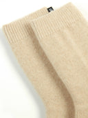 beige colored minimal socks with a small brand label "GOBI" on a light gray background #color_beige
