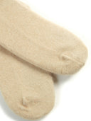 close up of front side of beige cashmere socks on a white background. #color_beige