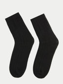 Pair of black socks on a light gray background #color_black