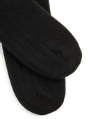 close up of black ribbed socks on a light gray background #color_black