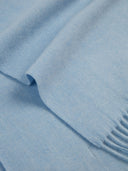 close up of a blue fringed scarf #color_light-blue