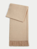 flat lay of a beige scarf with fringe in a light gray background.