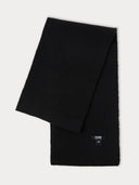 a black fisherman rib scarf with a small label "GOBI" on a light gray background #color_black