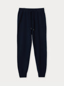 A pair of navy cashmere cuffed jogger pants with a drawstring waistband. #color_navy